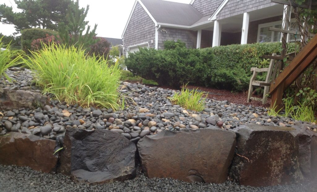 Natural stone landscape with ornamental plantings in Seaside Oregon