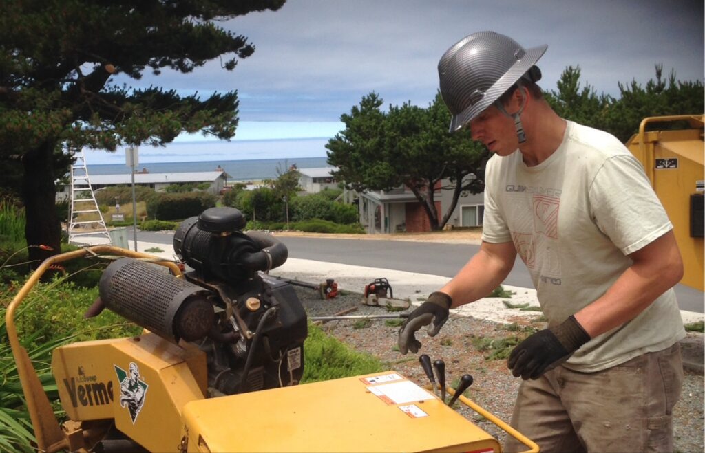 Cannon Beach Tree Service - operating a stump grinder.