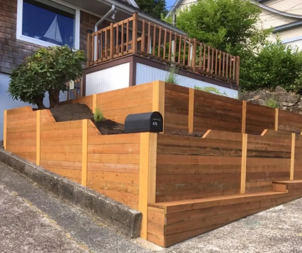 Tiered cedar retaining wall built on a sloped residential property in Astoria Oregon